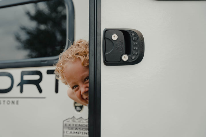 boy peering around door with RVLock handle