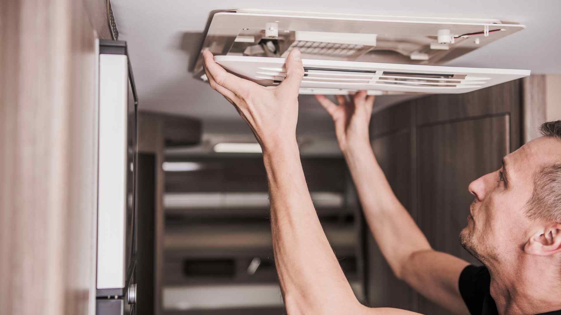 man checking air vent in Rv