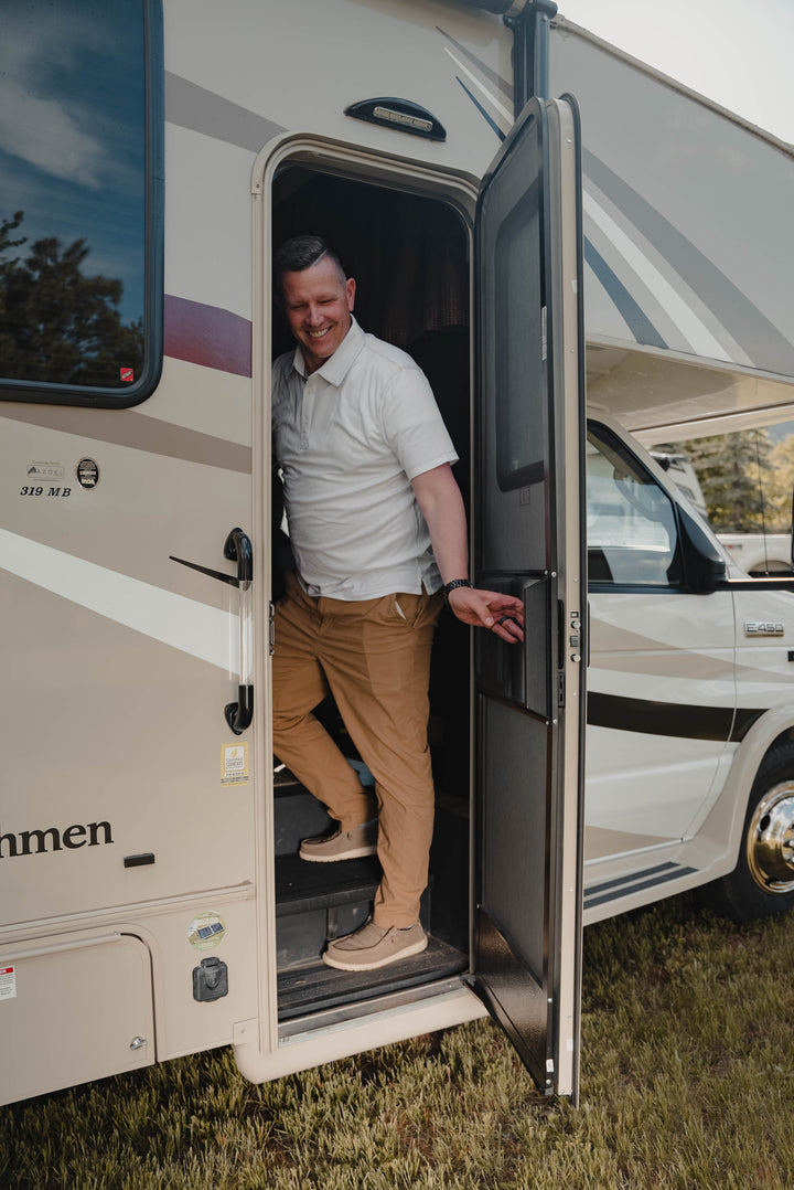 man closing door in motorhome